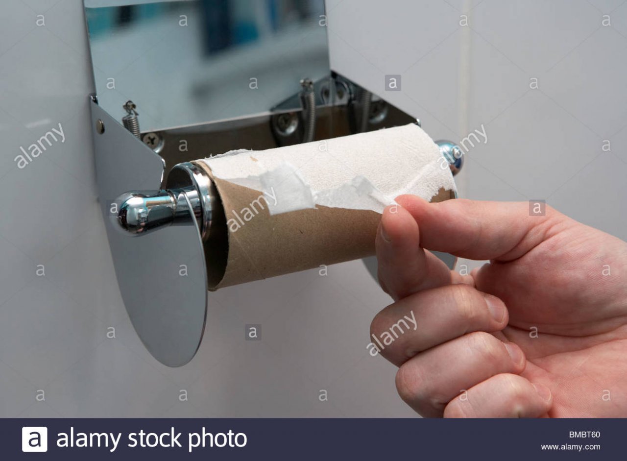 mans-hand-pulling-the-last-remaining-sheet-of-toilet-paper-on-a-toilet-BMBT60.jpg