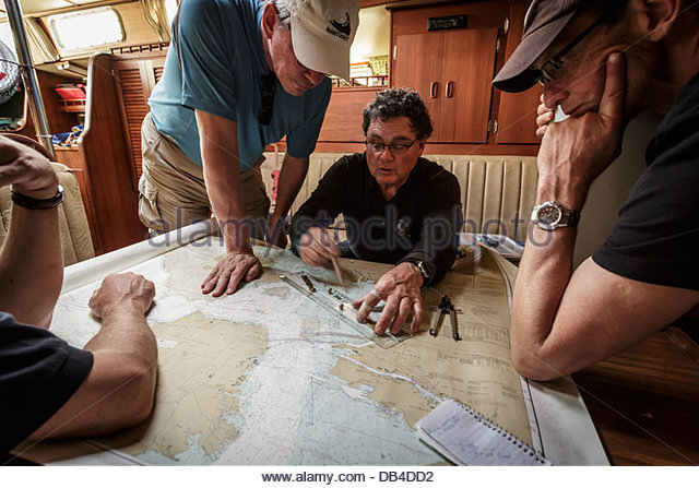 the-captain-and-crew-study-the-navigation-charts-to-determine-the-db4dd2.jpg