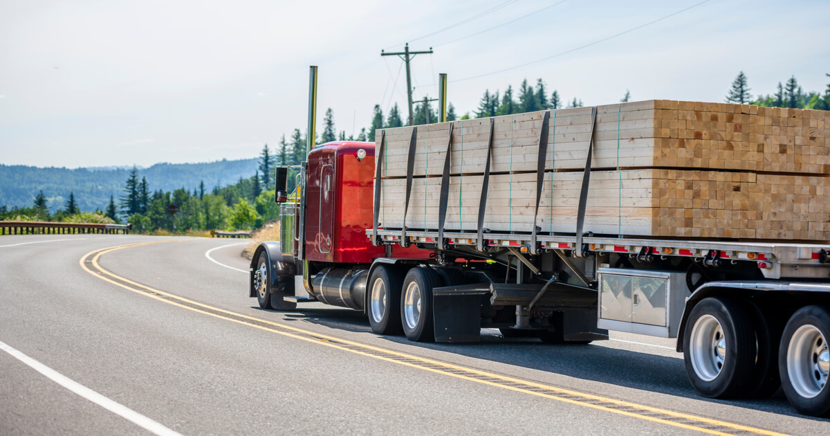 flatbed truck on highway with load