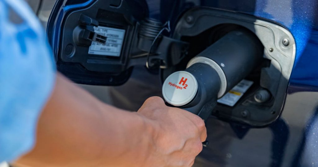 man refueling his hydrogen vehicle