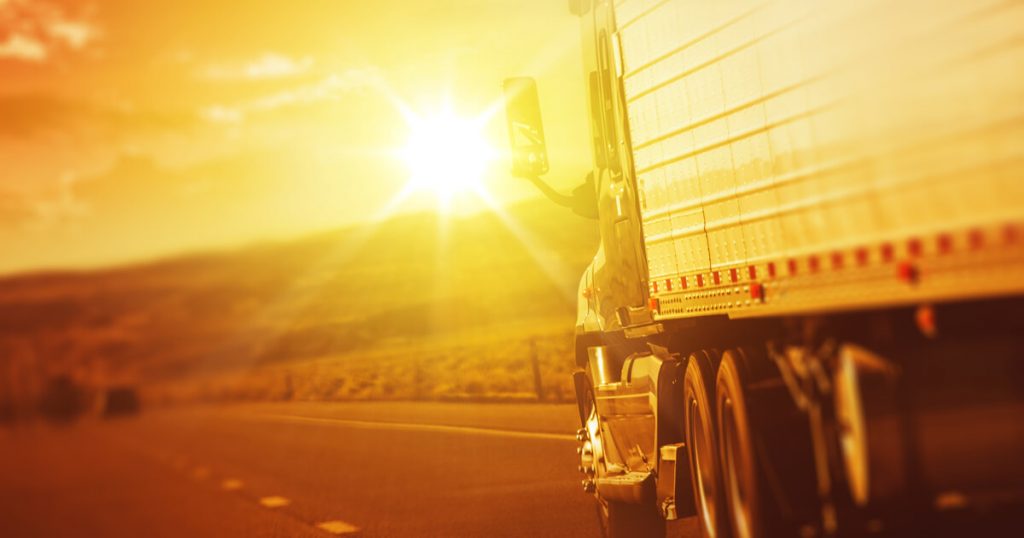 Semi driving on highway during summer