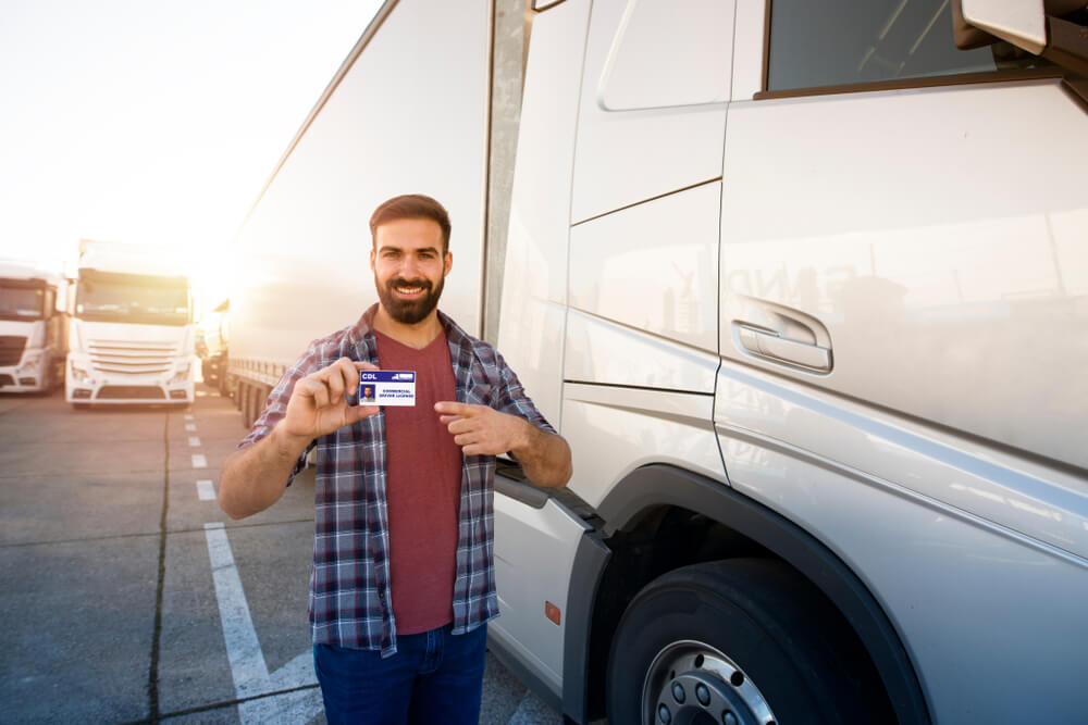 Driver holding cdl next to cab