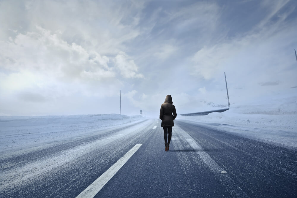 woman walking away on road