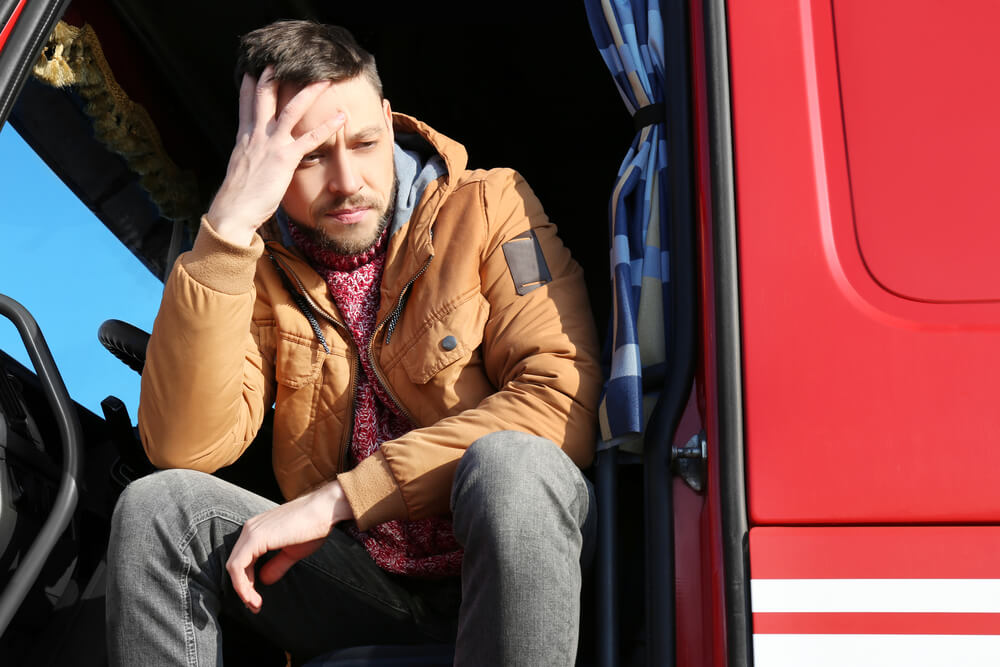 picture of an exhausted truck driver