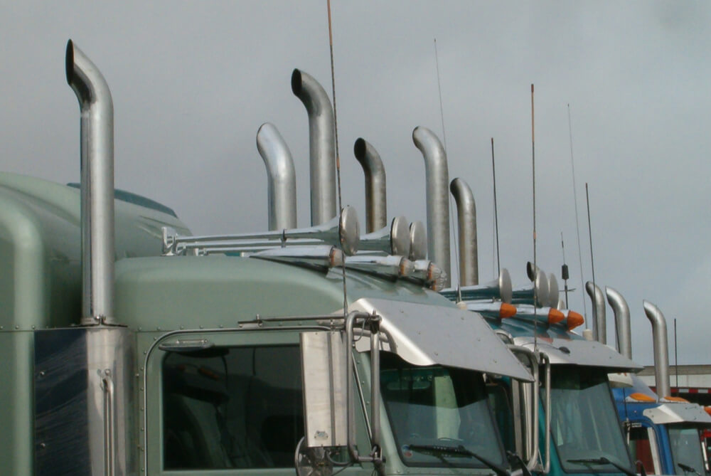 a close up of semi truck exhaust pipes